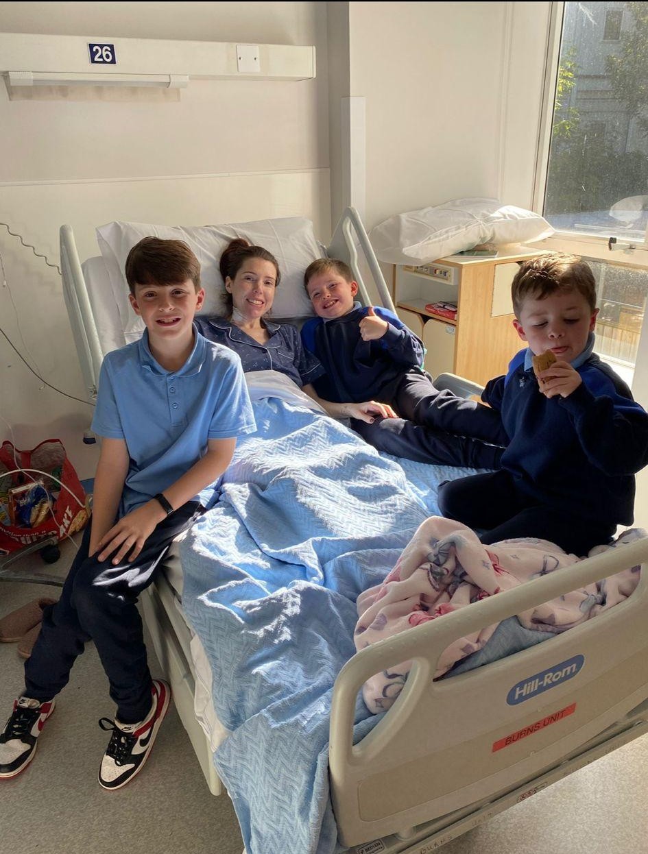 Susan white surrounded by her children post operation image