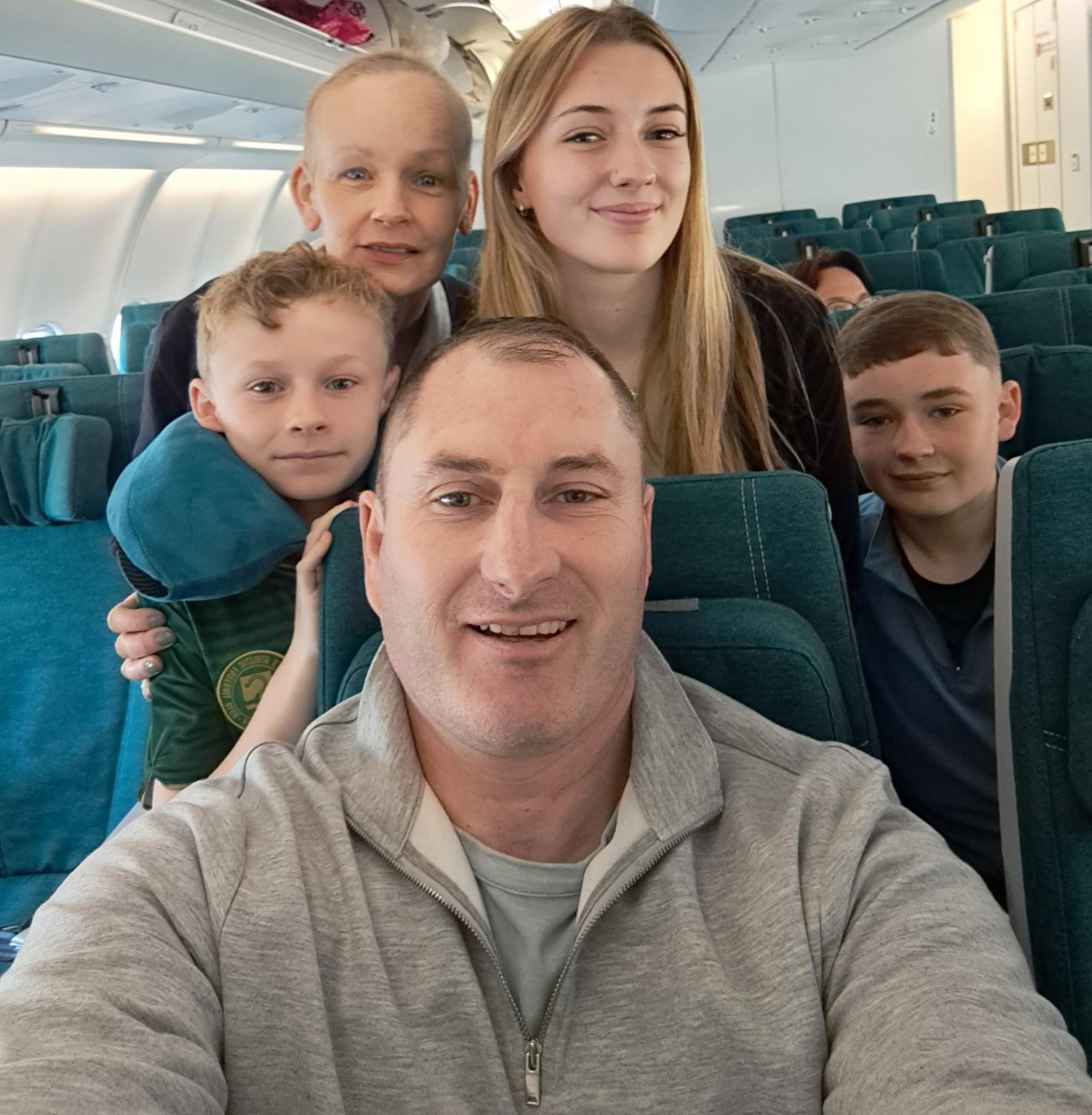 Colin Hawkins and his family on a plane