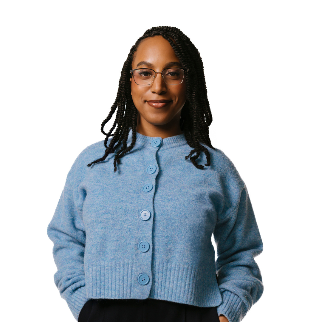 Person wearing a light blue button-up cardigan with ribbed hem and cuffs, standing against a white background. Hair is styled in long braids.