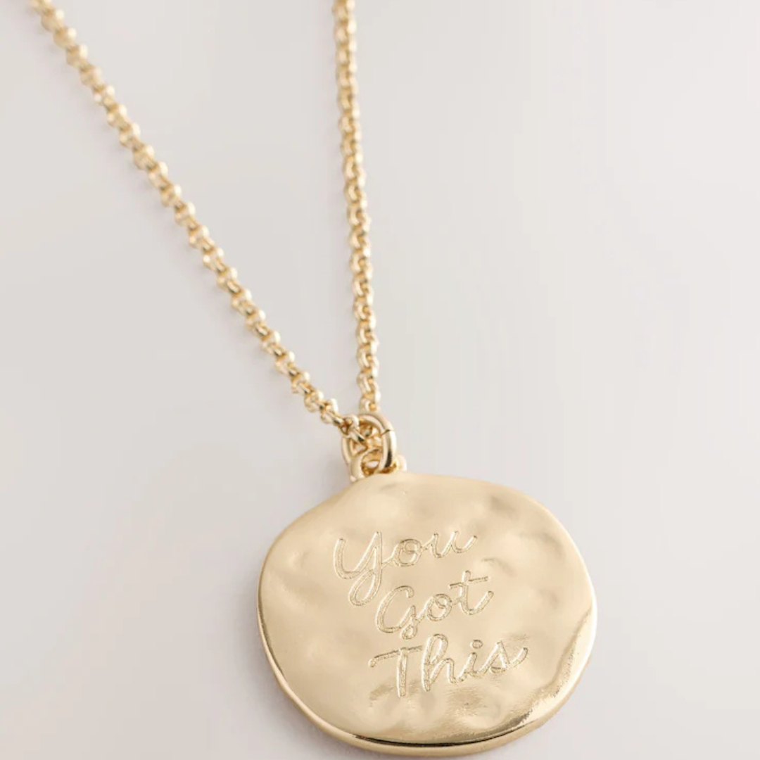 Image of a gold necklace that says you got this